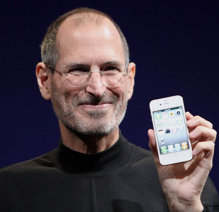 Black and white portrait of Steve Jobs holding an iPhone, headline Fired from his own company, The CMC AI Daily issue 001